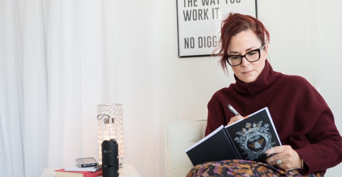 woman plans her day into her planner or diary