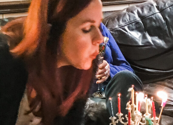 author blows out candles on birthday cake
